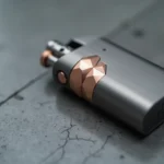 Briquet tendance 2026 en titane brossé avec incrustations or rose sur surface en béton poli